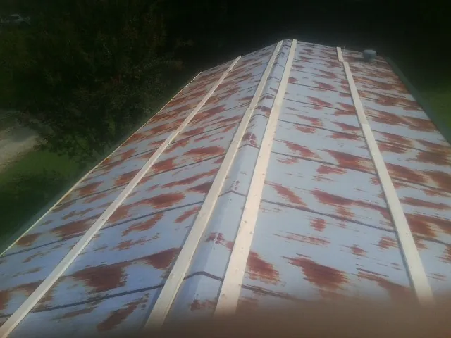 Rusted metal roof panels with new wood purlins before replacement — Storm Damage Roof Repair in Wilderville by Roofing Brothers